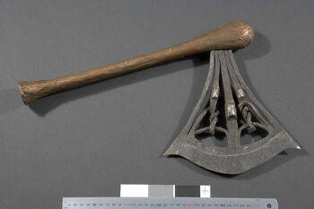 Museum number: UEM14571&amp;#160;
Material: Iron, wood and copper&amp;#160;
Region and culture: Kasaï, Songye people&amp;#160;
Description:&amp;#160;Large ceremonial axe with antropomorphical abilities. The blade is made from iron rods where 2 human faces appear. The shaft is made from copper. The blade is 21.7 cm in length, whilst the shaft is 39.5 cm long.&amp;#160;&amp;#160;
This&amp;#160;object&amp;#160;was&amp;#160;donated&amp;#160;to&amp;#160;the&amp;#160;Ethnographic&amp;#160;museum as part&amp;#160;of&amp;#160;Dr. Inge Heibergs&amp;#160;collection.&amp;#160;Approx&amp;#160;1903-1920&amp;#160;