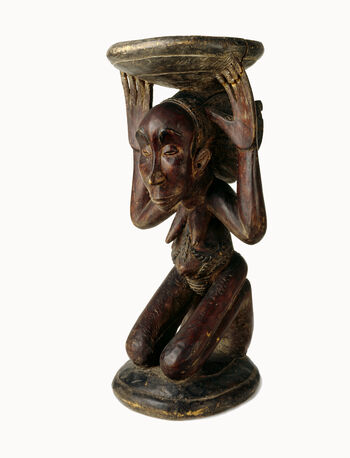 Museum number: UEM1775&amp;#160;
Material: Wood&amp;#160;
Region and culture: Luba Kingdom
Description:&amp;#160;A caryatid chair where a carved, kneeling woman is carrying the stool. It is in the shape of what is known as the Buli style, characteristic for the Luba people. The known Buli master who came from the village Kateba made the chair.&amp;#160;
Captain Sundt gave this chair to the Ethnographic museum.&amp;#160;1909.&amp;#160;
