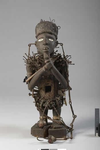 Museum number: UEM21037&amp;#160;
Material: Wood, iron&amp;#160;
Region and culture: Ibembe&amp;#160;
Description:&amp;#160;Power figure with spiritual attributions. Its strong, visual expression reflects the power that this figure is representing. This power figure was produced through a cooperation with a Congolese sculptor and a ritual specialist. The power figure has the ability to heal sickness, solve conflicts, protect established peace and punish those who wish to hurt others. The visible teeth are supposed to visualize aggression For instance, the nails hammered into the figure represent sufferings or ill wishes to those who have done harm. Height is approx. 60 cm.&amp;#160;
This power figure was given to the Ethnographic museum by Dr. Inge Heiberg and is a part of the Heiberg collection.&amp;#160;1903-1920.&amp;#160;