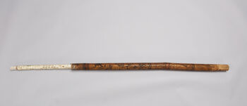 Museum number: UEM44011&amp;#160;
Material: bone, wood and bamboo&amp;#160;
Region and Culture: Might originate from a place between Angola and Kinshasa&amp;#160;
Description:&amp;#160;Bamboo rod with incised décor. Remains of a secondary montage of a floor lamp is visible as well. The rod displays seven separate sections with images of anthropomorphic and zoomorphic motifs. Judging by the style of the rod, it could originate from the southern part of the Congo-basin, presumably the border between Angola and Kinshasa. Length 94, 5 cm. Diameter: 4 cm.&amp;#160;&amp;#160;
The object was collected by watchmaker Fredrik August Michelet and was donated to the Ethnographic Museum by Randi Schrader Nielsen. Date for donation is currently unknown.&amp;#160;&amp;#160;