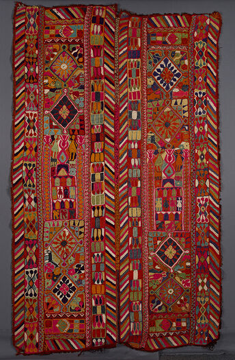 (UEM49192) Double bordered on&amp;#160;the&amp;#160;vertical sides of the two panels. Characteristic multi-colored diagonal lines pattern on&amp;#160;the&amp;#160;inner and outer edges of both panels. Each panel is divided into three sections. Outer sections of each panel: two diamonds surrounded by flowers, animals, and human figures. The central section of each panel: a possible architectural element with birds animals and human figures.&amp;#160;