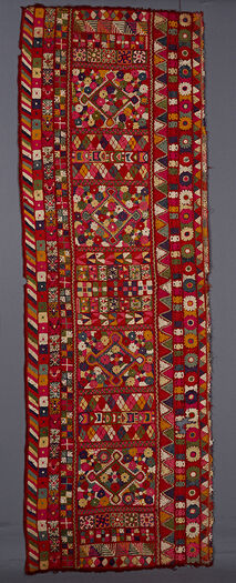 (UEM49196) One of the two panels has been removed.&amp;#160;The outer edge has the characteristic multi-colored diagonal lines pattern. The central area is divided into sections with big diamonds these are divided by alternating sections with chequered/geometrical motifs. The big diamonds contain flowers and are also surrounded by flowers. This blanket is not decorated with living creatures.&amp;#160;
