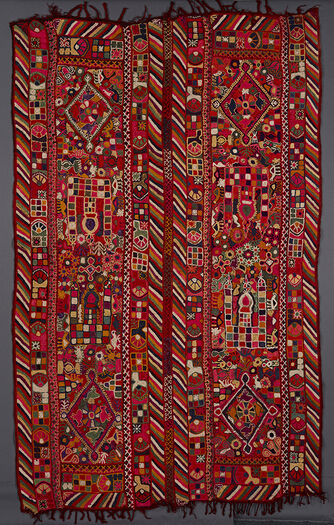 (UEM49199) The&amp;#160;vertical edges have double borders&amp;#160;with the multicloured diagonal lines pattern on all four edges. The centre of both panels is divided into three sections. Each outer section has a diamond which is decorated with flowers and living creatures (camels, birds, insects and human figures) on the inside and outside. In the big middle section of each panel there are two architectonic motifs (possibly a mosque) with their roofs converging towards the centre. Otherwise all over decoration of geometric and vegetal motifs.&amp;#160;