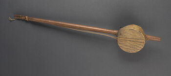Museum number: UEM183
Material: Coconut, fish skin, unknown fibre, vegetal material&amp;#160;
Region and culture: Unknown origin. Registered&amp;#160; New Zealand in the museum database, but this might possible be incorrect.
Description:&amp;#160;Although the catalogue text states that this instrument derives from New Zealand, this has to be incorrect. Most likely can the whole of Polynesia be excluded as possible place of origin. It may be an ancient Indian musical instrument known as&amp;#160;Agappai kinnari. The object appear to be a guitar made from coconut and fish skin. Two strings are attached to the bamboo stem that crosses over the soundbase. There are four holes on the bottom of the soundbase. Production date and place of origin is unknown.&amp;#160;&amp;#160;
Place of origin is unknown. The instrument was collected by Fredrik Ring when he was a tradesman in Valparaiso, Chile during the 1820s. Konsul Ring donated the object to the Ethnographic Museum in 1833.&amp;#160;&amp;#160;